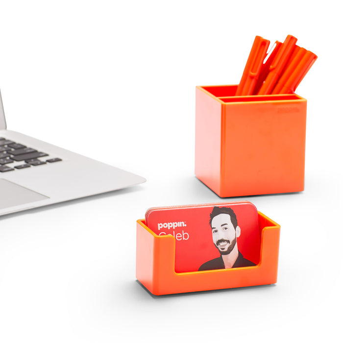 "Modern workplace with laptop, orange stationary holders and business card holder on white background (Orange)