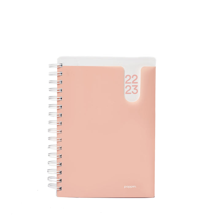 Peach-colored 2023 planner with spiral binding on white background (Blush)