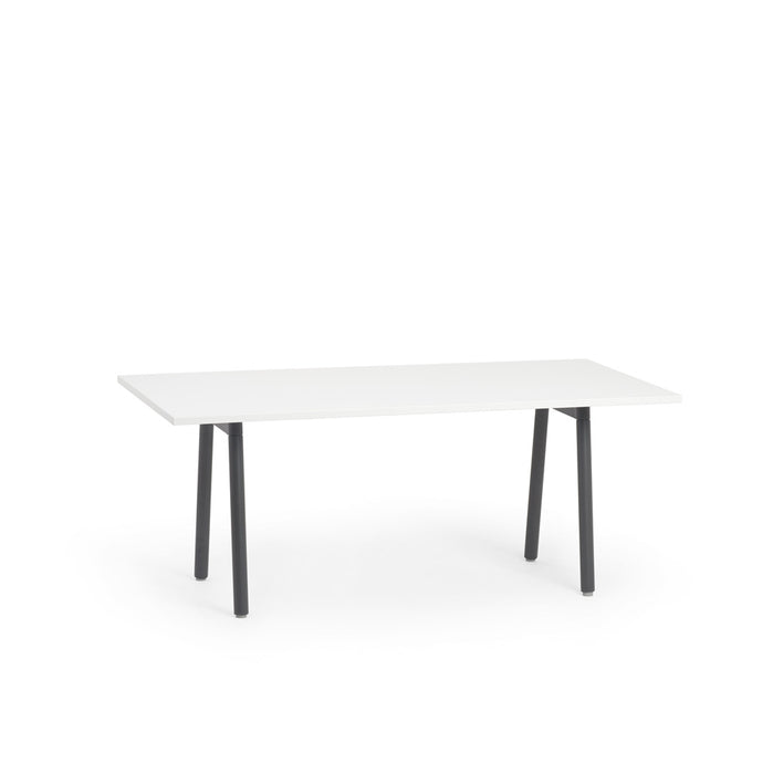 Modern white rectangular table with black legs on a white background. (White)