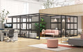 Modern office interior with cubicles, plants, and comfortable seating areas. (Black-Open)