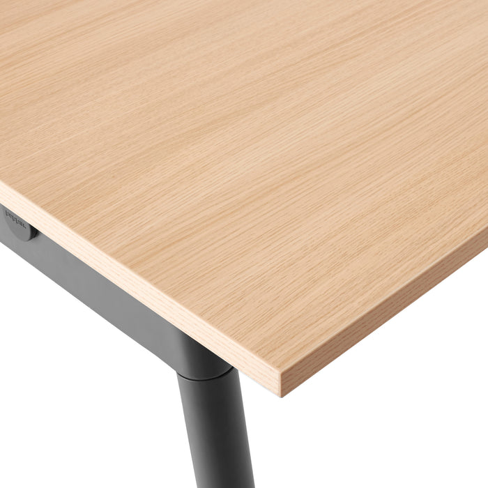 Close-up view of a modern wooden desk corner with metal legs on a white background. (Natural Oak-72&quot; x 36&quot;)(Natural Oak-96&quot; x 42&quot;)(Natural Oak-124&quot; x 42&quot;)(Natural Oak-144&quot; x 36&quot;)