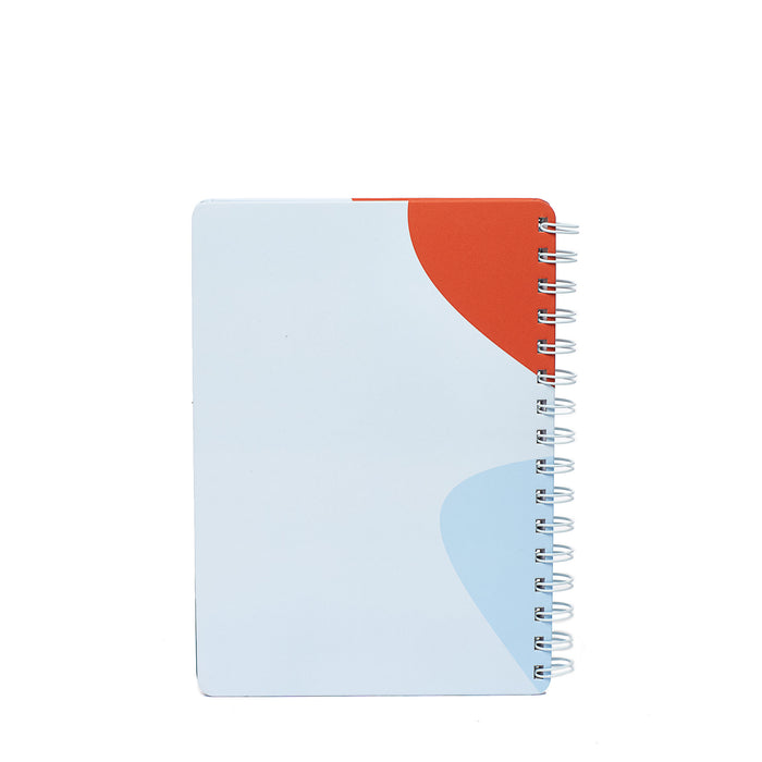 Spiral notebook with blue and orange cover design on white background. (Sky)