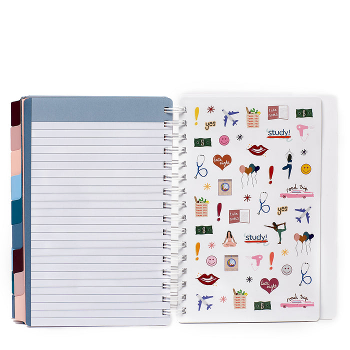 Lined notebook with colorful tabs open next to a sheet of fun assorted stickers. (Slate Blue)