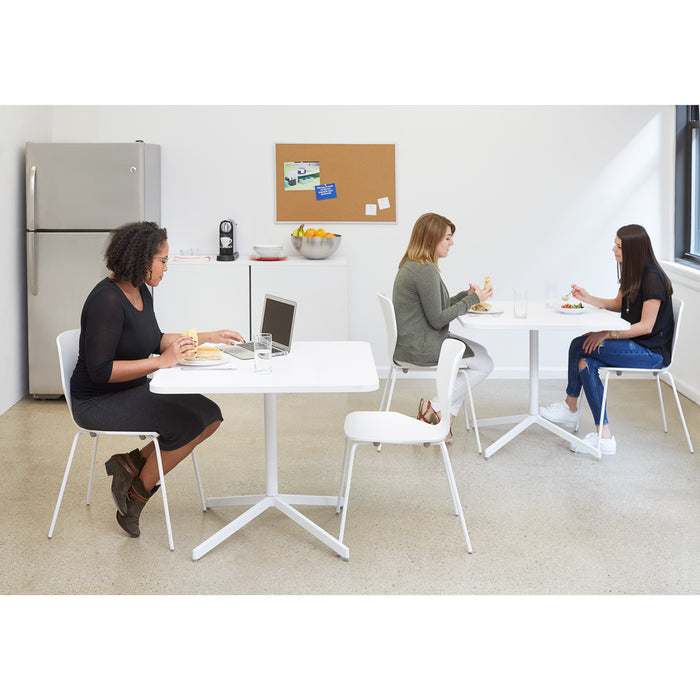 Three women enjoying a lunch break in a bright office kitchen area. (White-36&quot;)