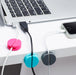 Cable organizers on desk with laptop and smartphone charging. (White)