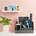 Modern desk organizer with office supplies and plant against a pink wall. (Dark Gray)