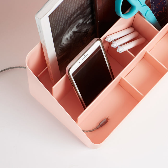 Smartphone and headphones in a pink organizer on a desk (Blush)