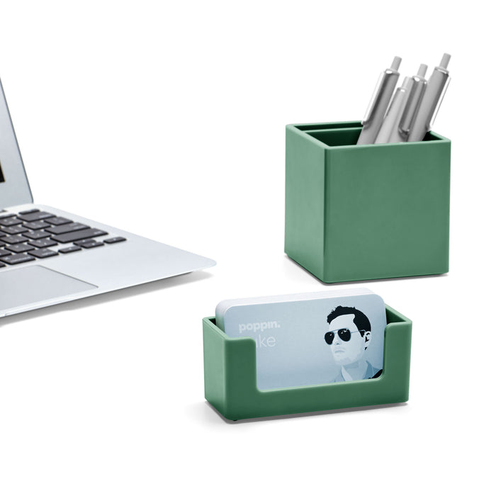 Modern workspace with laptop, green stationery holder, and business card case. (Sage)