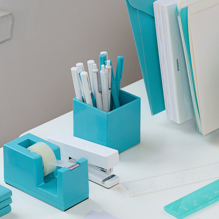 Blue office supplies on a desk including pens, stapler, and tape dispenser (Aqua)