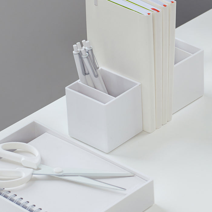Organized white desk accessories, including notebooks, pens, and scissors on a clean (White)