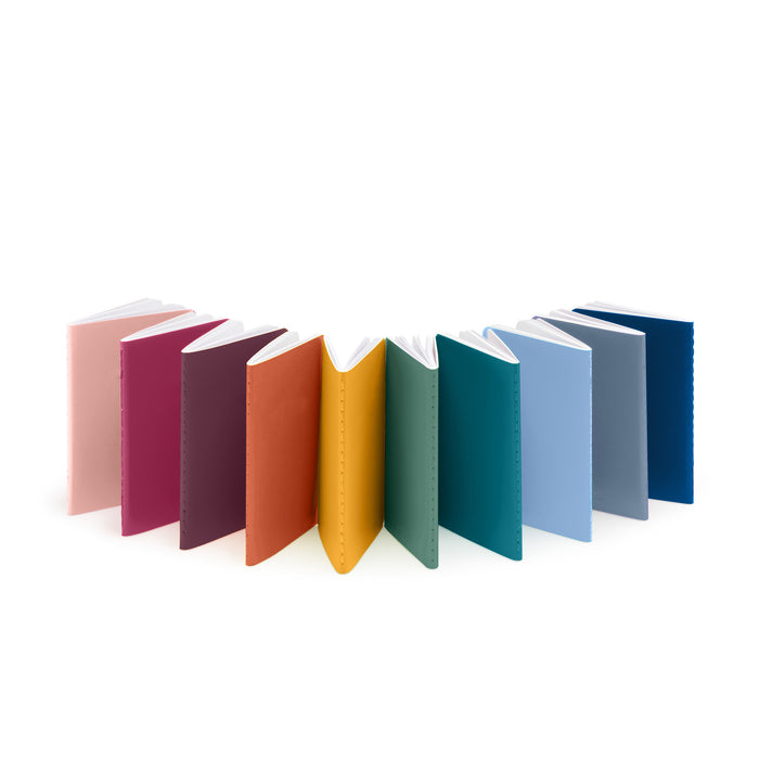 Row of colorful standing books on white background 