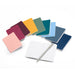 Colorful assortment of closed notebooks with one open notebook and pen on white background. 