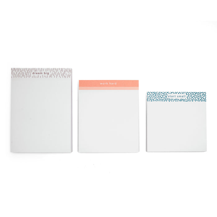 Three minimalist notebooks with motivational phrases on white background. 