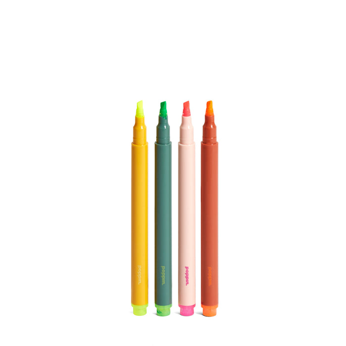 Assorted colorful markers standing upright on a white background. 