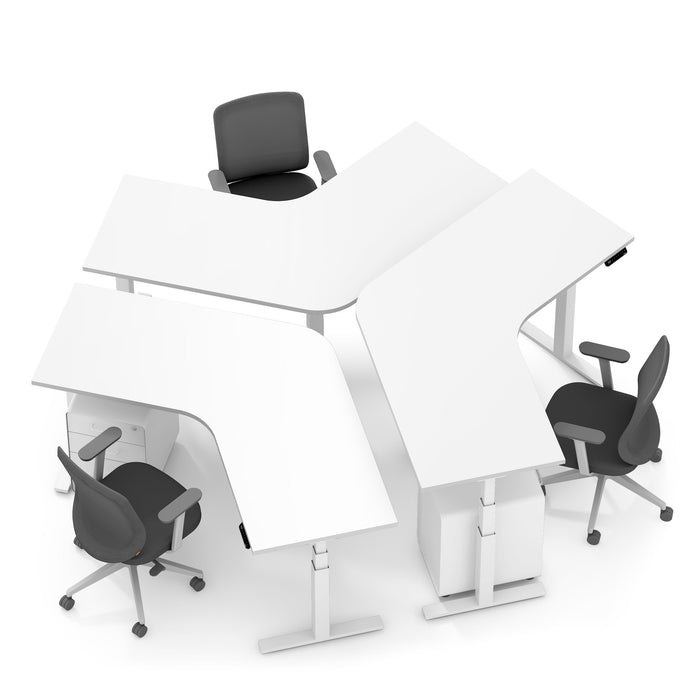 Modern white office desks arranged in a pod with ergonomic black chairs on a white background. 