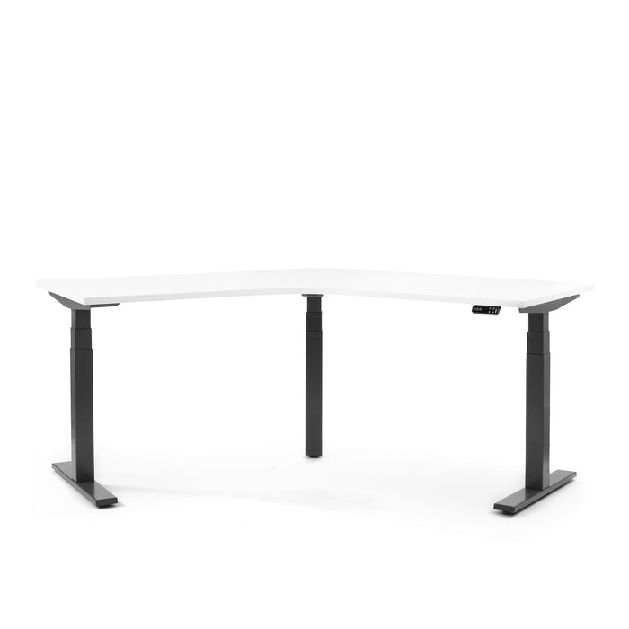 Modern white height-adjustable desk with black legs on white background. 
