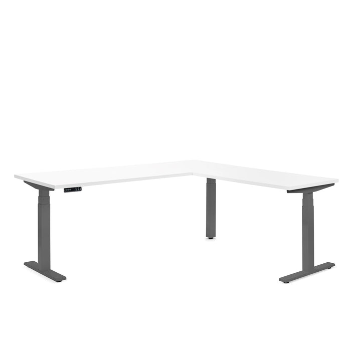 White L-shaped adjustable standing desk with electronic controls on white background. (White)