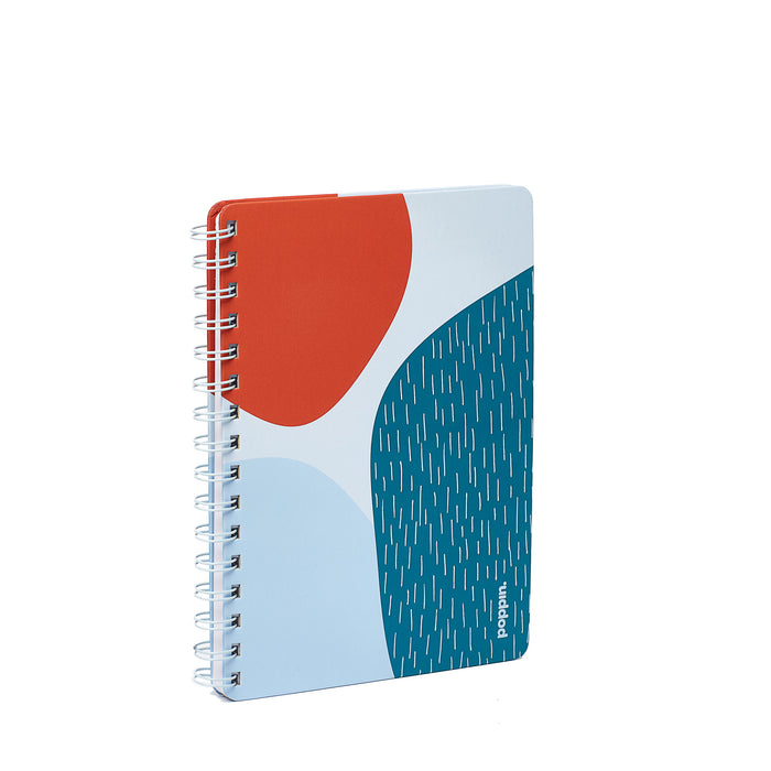 Blue and red abstract design spiral notebook on white background. (Sky)