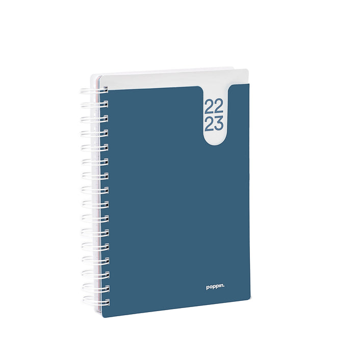 2023 spiral-bound planner notebook with blue cover standing upright. (Slate Blue)