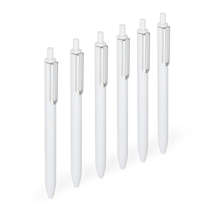 "Set of white pens with silver clips arranged in a row on a white background 