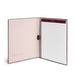 Open notebook with blank pages and elastic closure on white background. 