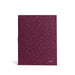 Burgundy notebook with textured cover standing against white background. 