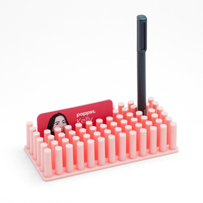 "Poppin brand pink desk organizer with slots for cards and a pen isolated on (Blush)