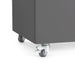 Swivel caster wheel on a modern grey storage cabinet against a white background. 