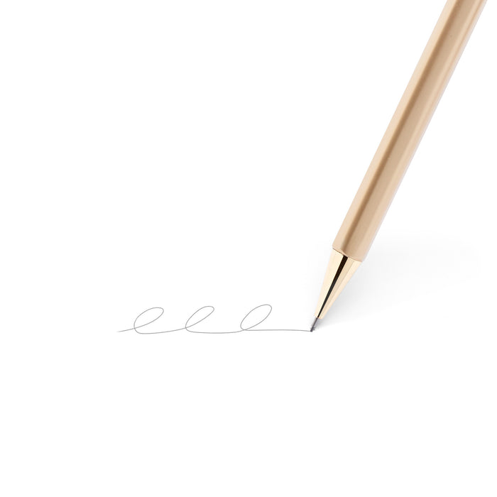 Gold pen tip writing a wavy line on white background. 