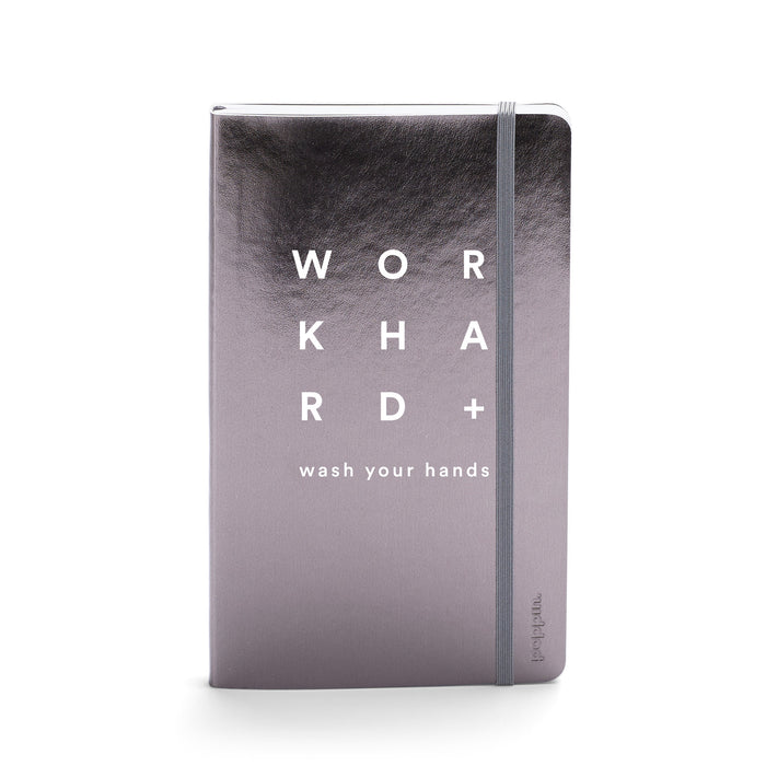 Silver hardcover notebook with 'Work Hard' text and hand-washing reminder on white background. 