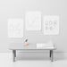 Minimalist office with whiteboard graphics, desk organizer, and bench on a gray background. 