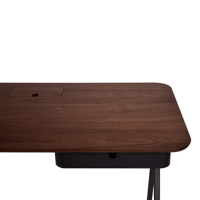Corner view of a modern walnut desk with built-in cable management on a white background. (Walnut)