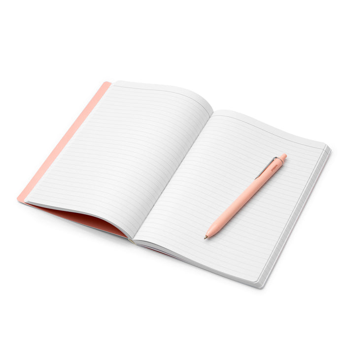 Open notebook with blank pages and pink pen on white background. (Blush)