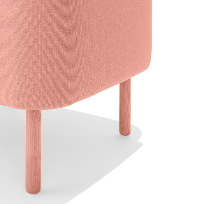 Peach pink round ottoman with wooden legs on a white background (Blush)