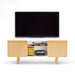 Flat-screen TV on wooden TV stand with books and decorative items against a white background. (Natural Ash)