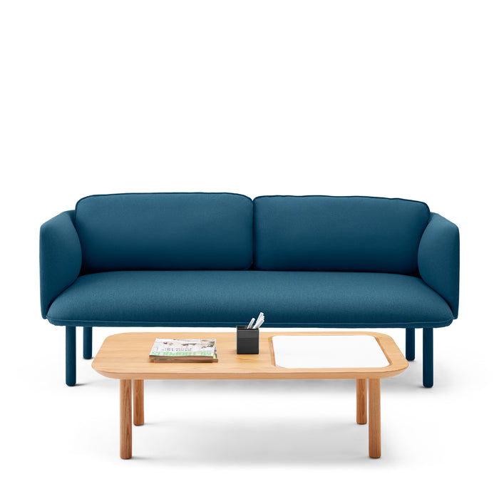 Modern blue sofa with wood accents and coffee table with books and stationery on a white background. (Dark Blue)
