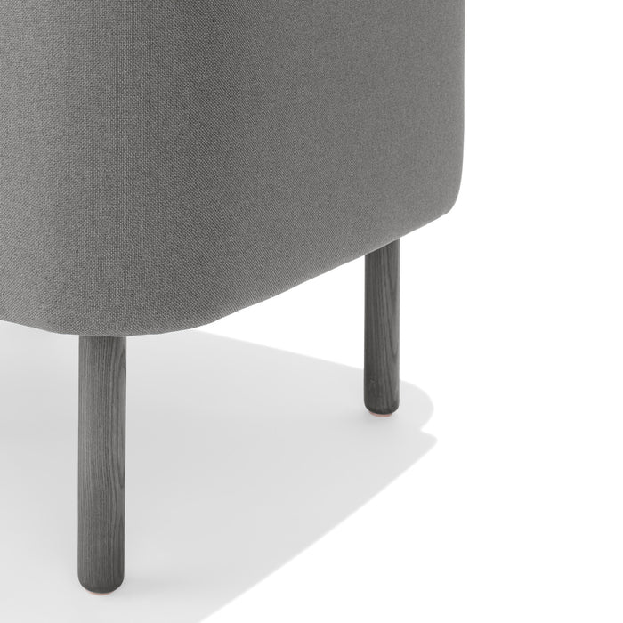 Gray upholstered ottoman with wooden legs on a white background. (Gray)