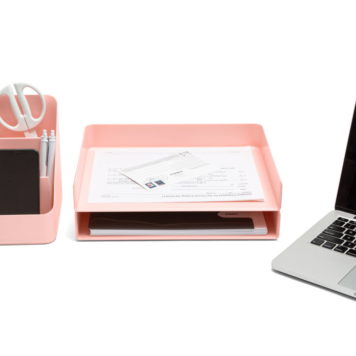 Office desk with laptop, pink tray with documents, and stationery organizer. (Blush)