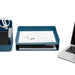 Office desk with laptop, blue document tray, and stationery holder on white background. (Slate Blue)