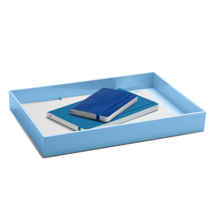 Blue desk organizer tray with notebooks and papers on white background. (Sky)