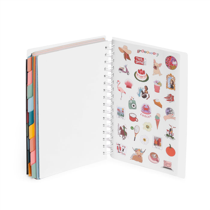 Open notebook with colorful stickers on right page and tabs on left edge. (Blush)(Slate Blue)(Dark Gray)