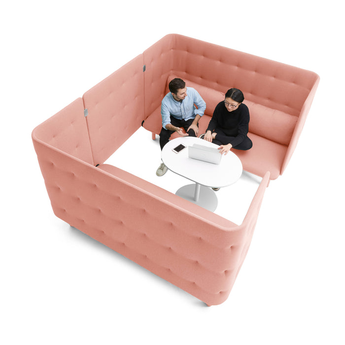 Two professionals collaborating over a laptop in a modern pink office booth. (Blush-Blush)