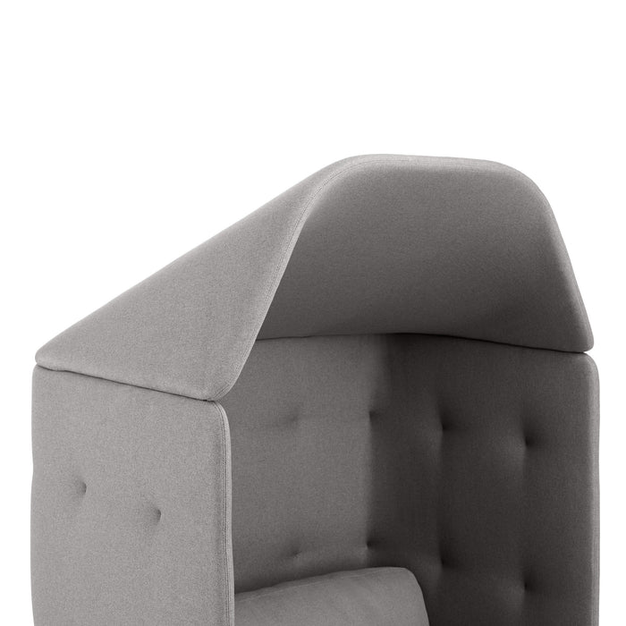 Close-up of a gray tufted armchair with clean lines against a white background. (Blush-Gray)