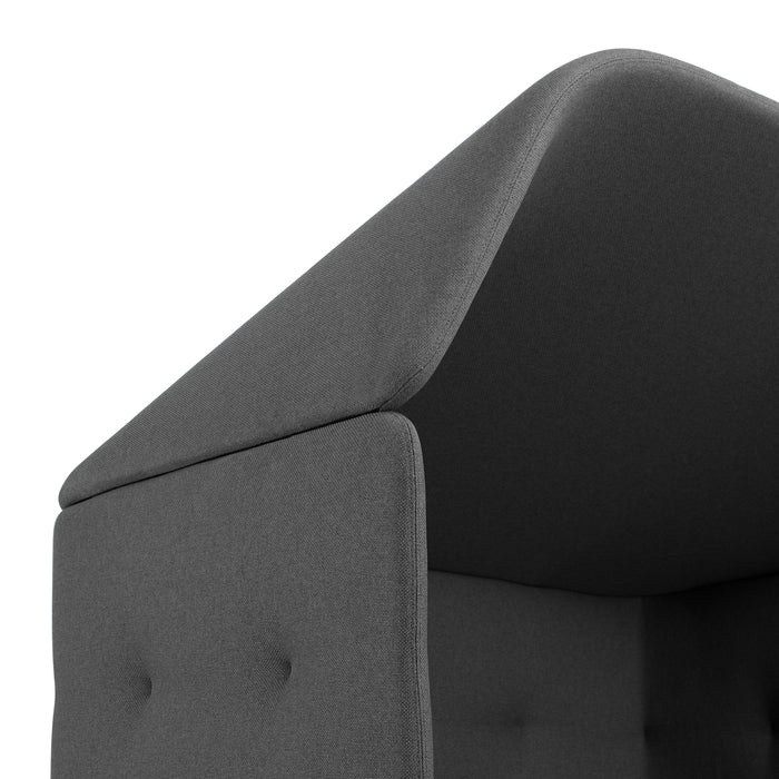Close-up view of a dark grey fabric upholstered chair back with button detail. (Brick-Dark Gray)