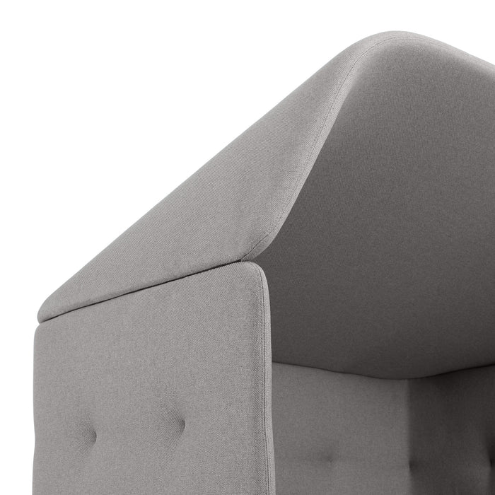 Close-up view of a gray upholstered chair's headrest and arm detail. (Gray-Gray)