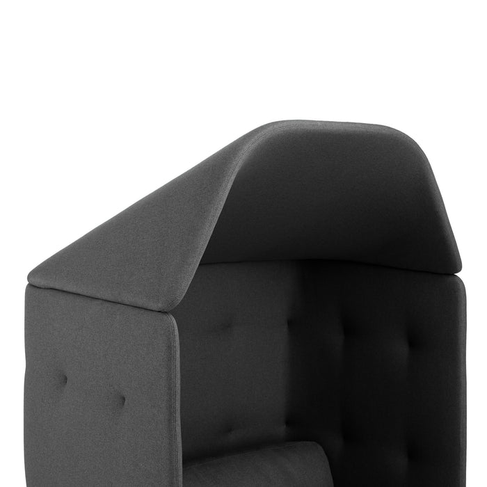 Close-up view of a modern grey upholstered chair's backrest with tufted details on a white background. (Teal-Dark Gray)