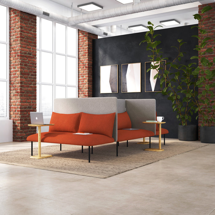 Modern office lounge with red sofas, black wall, and indoor plants. (Dark Gray-Dark Gray)(Brick-Dark Gray)(Dark Blue-Dark Gray)(Teal-Dark Gray)(Gray-Gray)(Blush-Gray)(Brick-Gray)(Dark Blue-Gray)