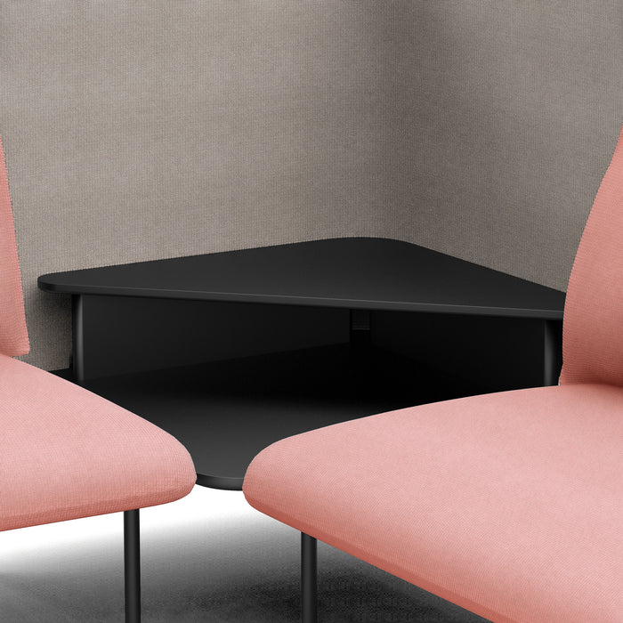 Modern black coffee table between two pink chairs with gray textured backdrop. (Blush-Gray)