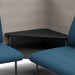 Modern black corner table with blue upholstered chairs in a minimalist office setting. (Dark Blue-Gray)