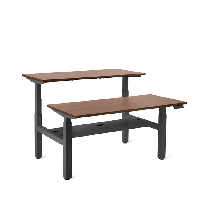 Adjustable height modern desk with wood finish and black frame on a white background. (Walnut-57&quot;)